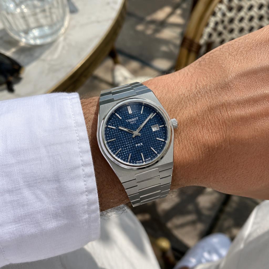 Illustrative lifestyle photo of a blue-dial watch on a wrist